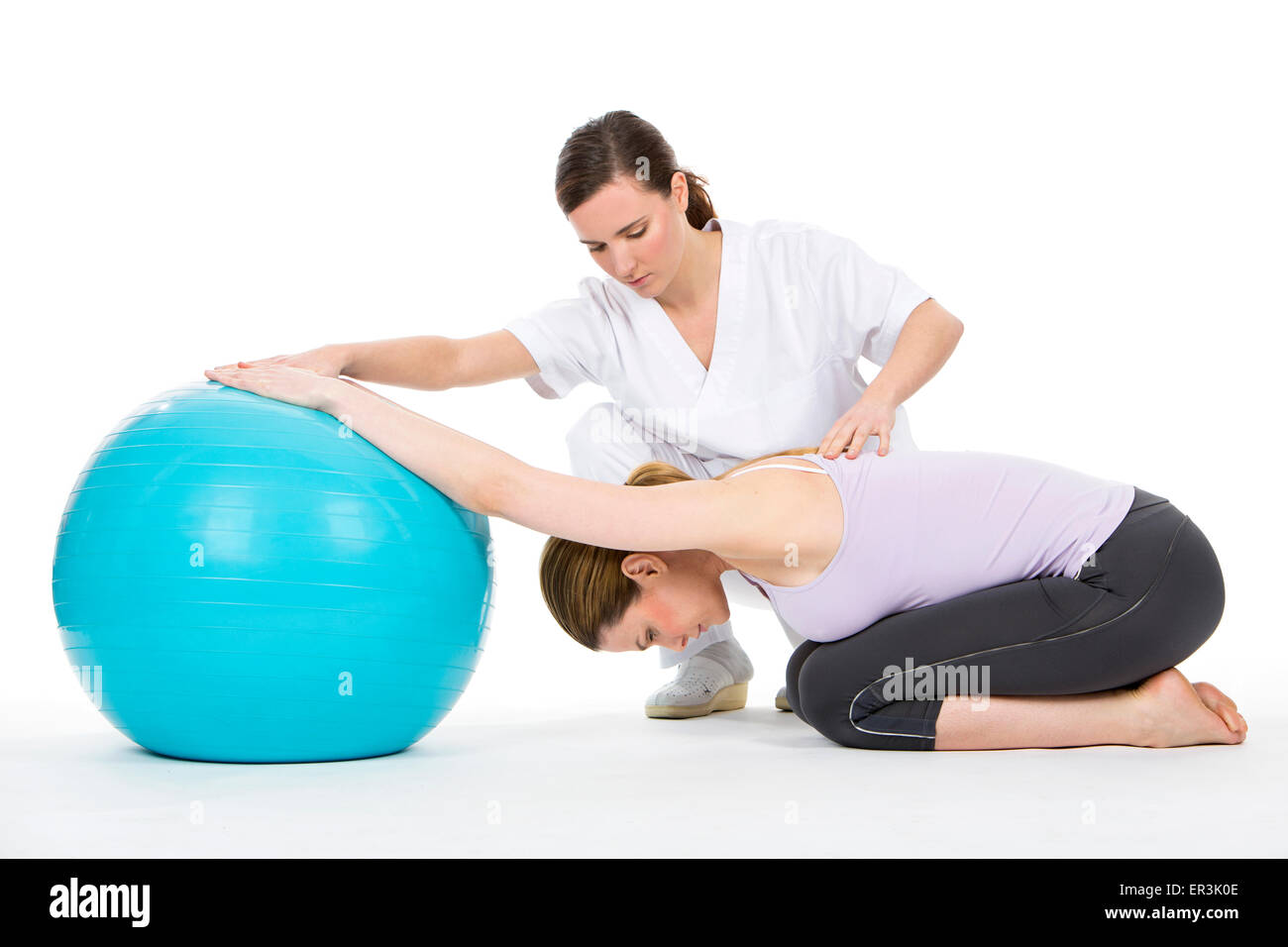 woman with physiotherapist exercising and reinforcing the vertebral column Stock Photo