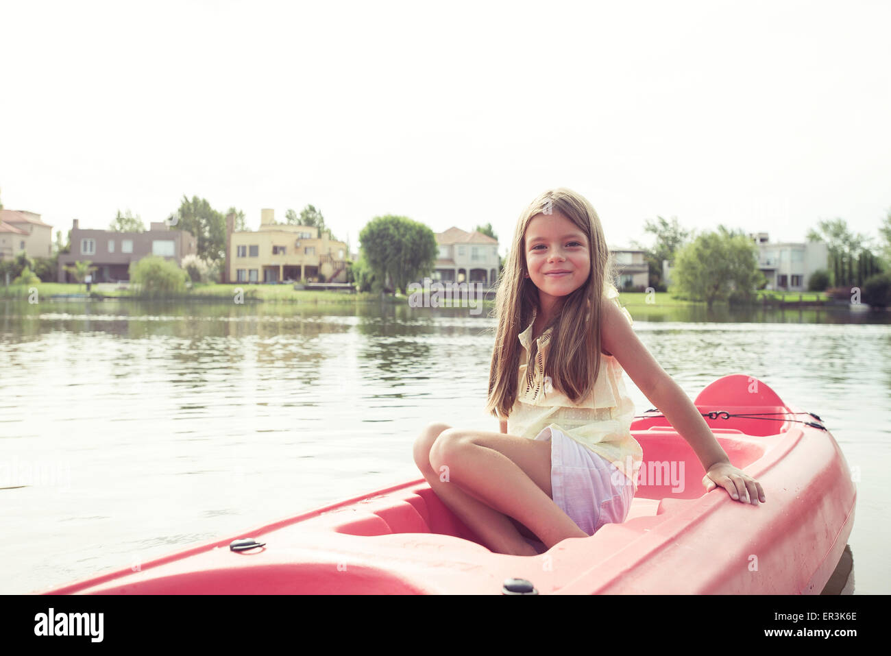 Girl kayaking on lake Stock Photo