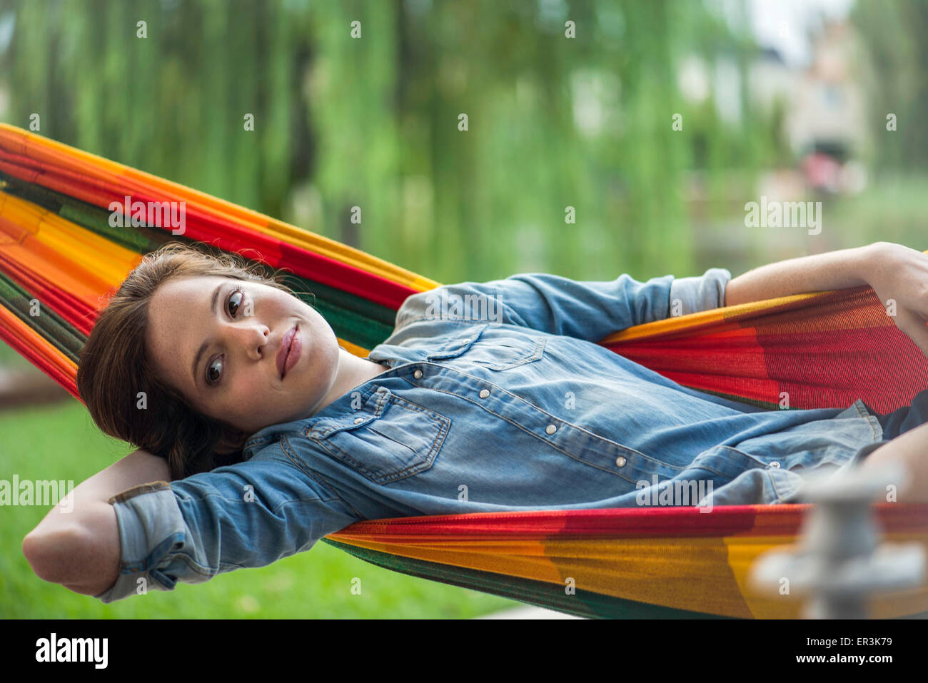 Woman relaxing in hammock Stock Photo - Alamy