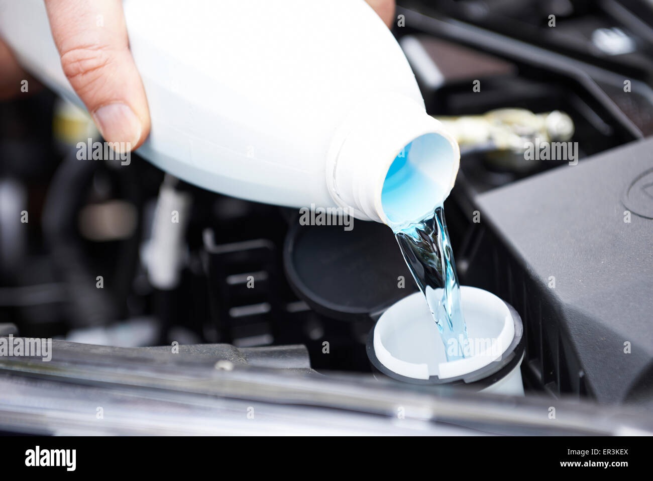 Filling the windshield washer fluid on a car Stock Photo - Alamy
