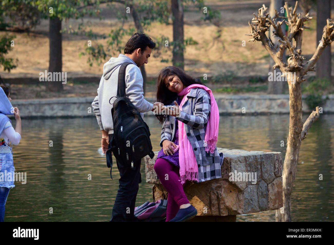 Young Indian couple exchanging selfies Lodhi Gardens Delhi India 14th Feb 2015 Stock Photo