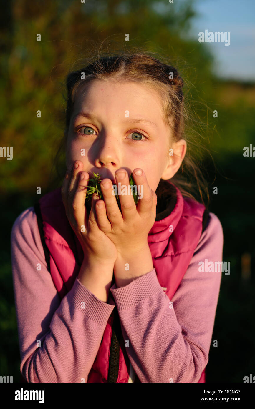 Little girl eats grass Stock Photo Alamy