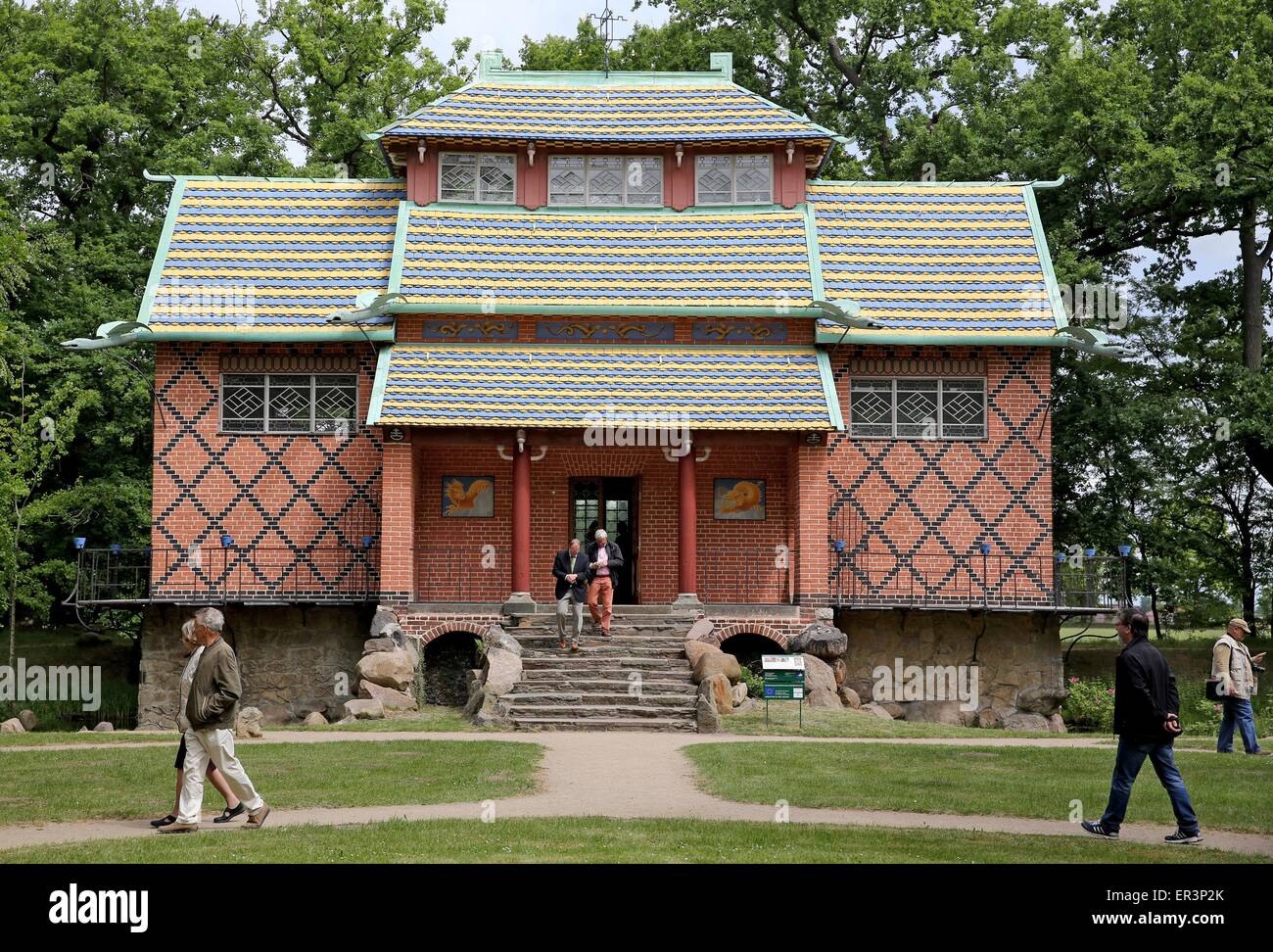 Visitors stand in front of the renovated Chinesisches Haus (lit. Chinese House) located inside the park of Oranienbaum Palace in Oranienbaum, Germany, 26 May 2015. The interior decoration has seen extensive restoration over the last two years. The painted paper wallpapers and the furniture were partially reconstructed. The teahouse built by Franz, Duke of Anhalt-Dessau, in 1795 has undergone extensive refurbishment since 2009 at a total cost of 1.3 million euros and is now open to the public. It is the centrepiece of the only currently still largely preserved English-Chinese garden from the 18 Stock Photo