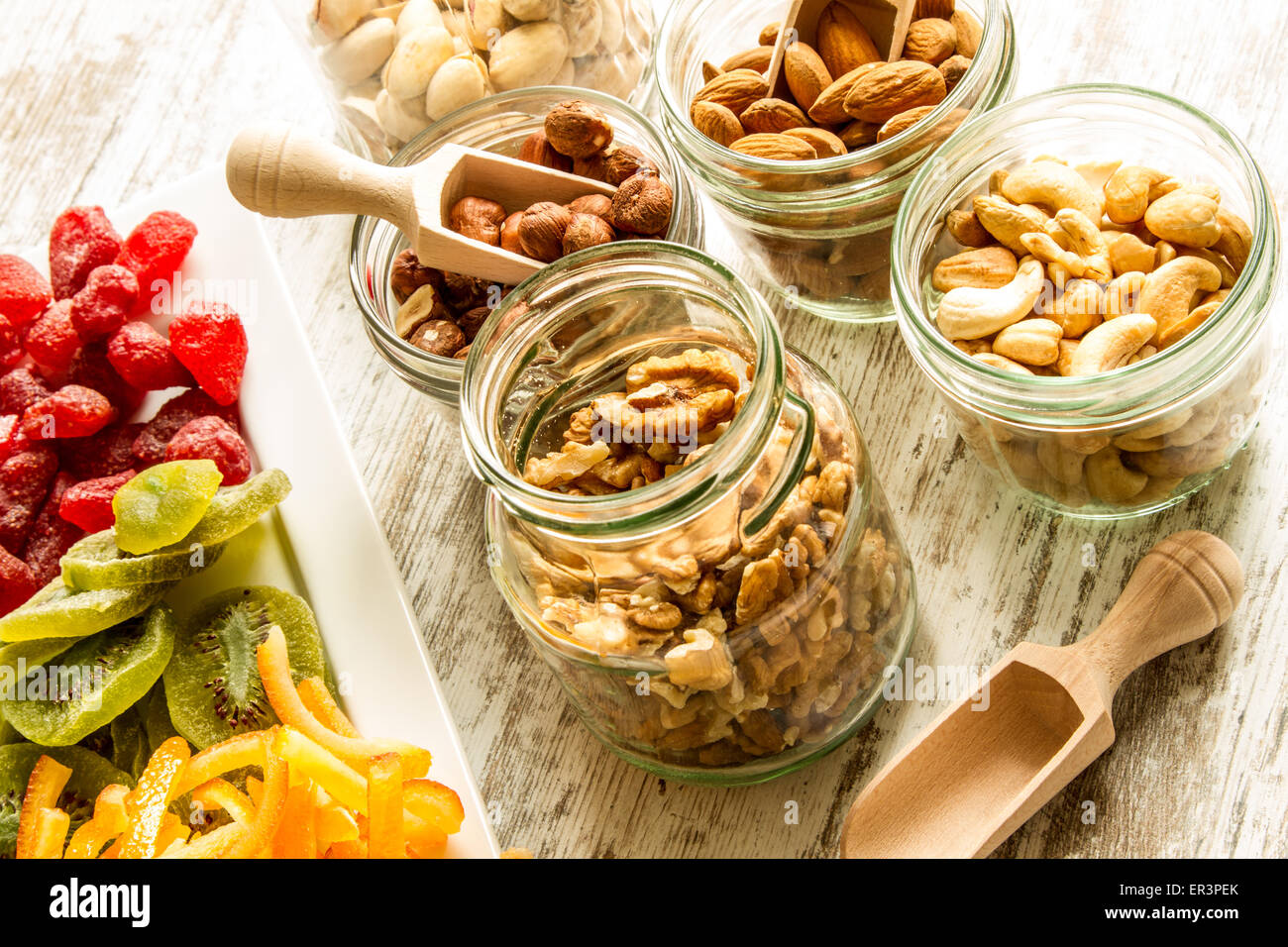 Selection of dried fruits in jars and on a plate Stock Photo