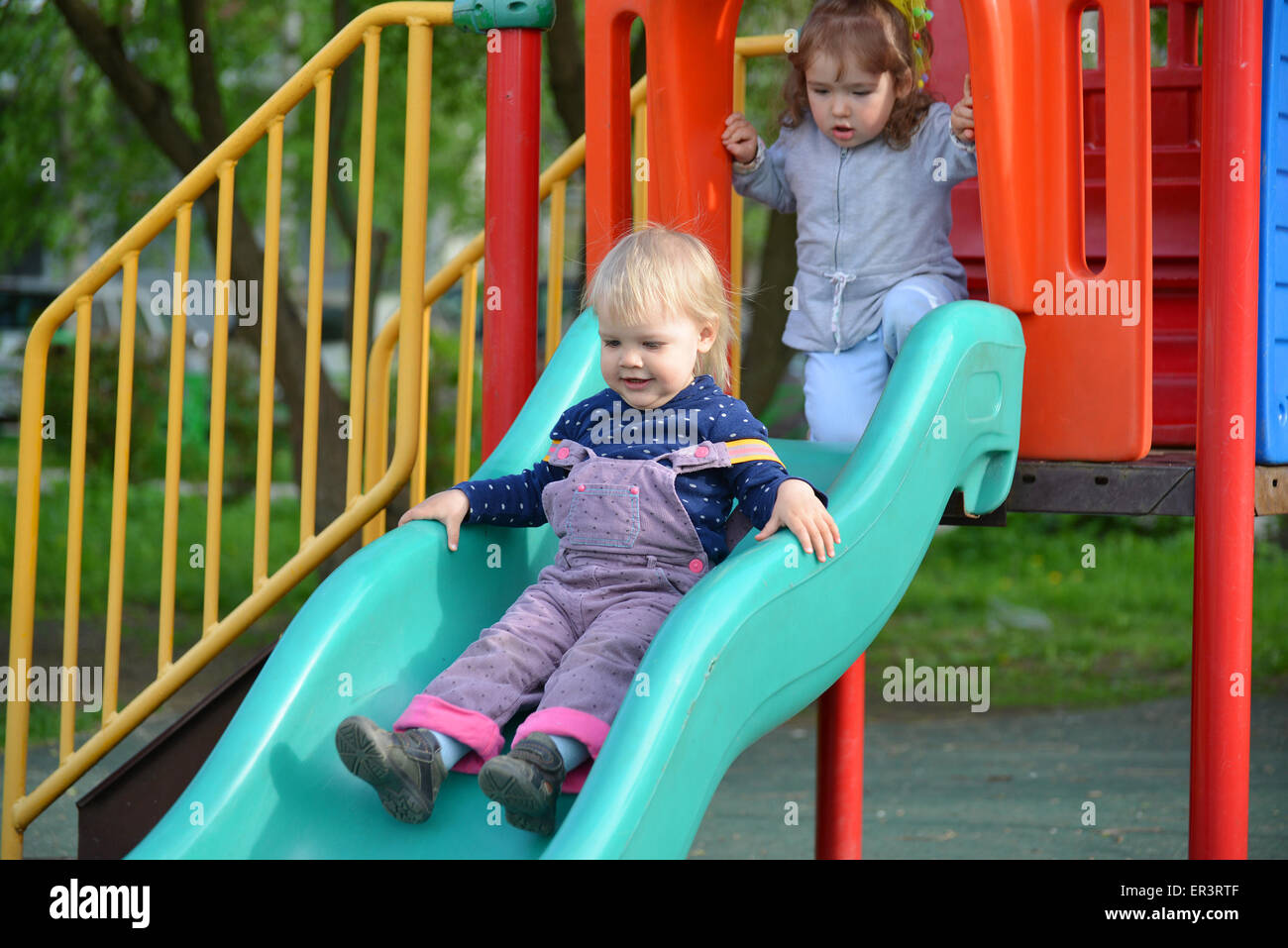 Two little girls playing on the playground Stock Photo - Alamy