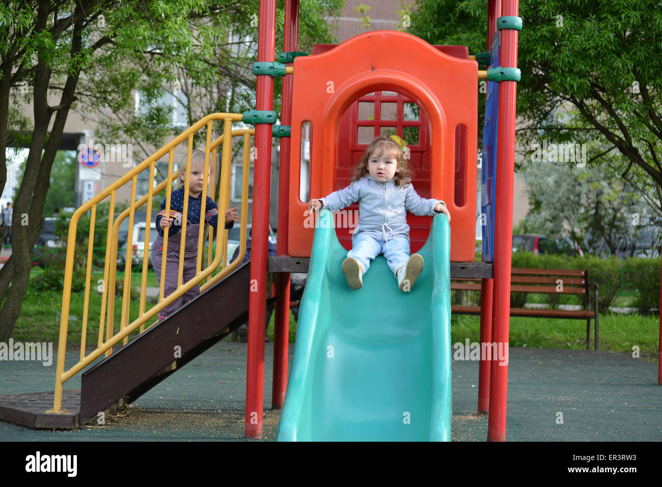 Two little girls playing on the playground Stock Photo - Alamy