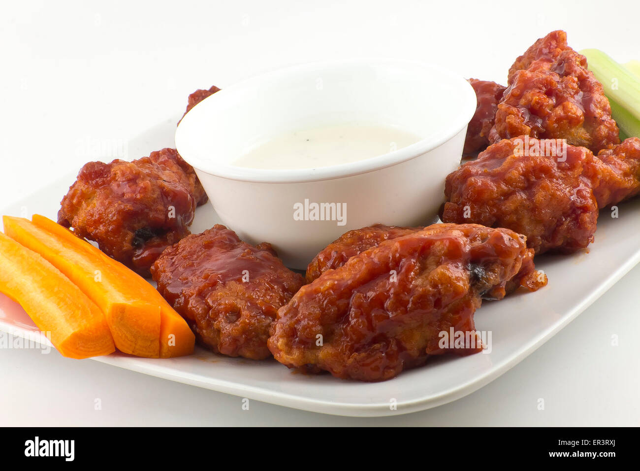 Spicy BBQ Buffalo Chicken Wings with carrot sticks and celery and