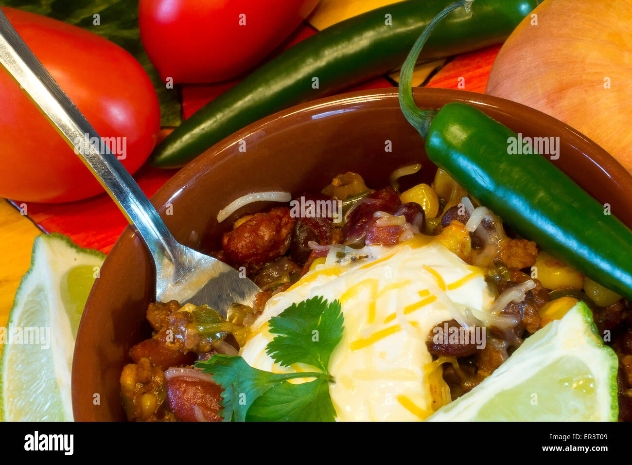 Hot and spicy Chili con carne garnished with cilantro and topped with sour cream Stock Photo