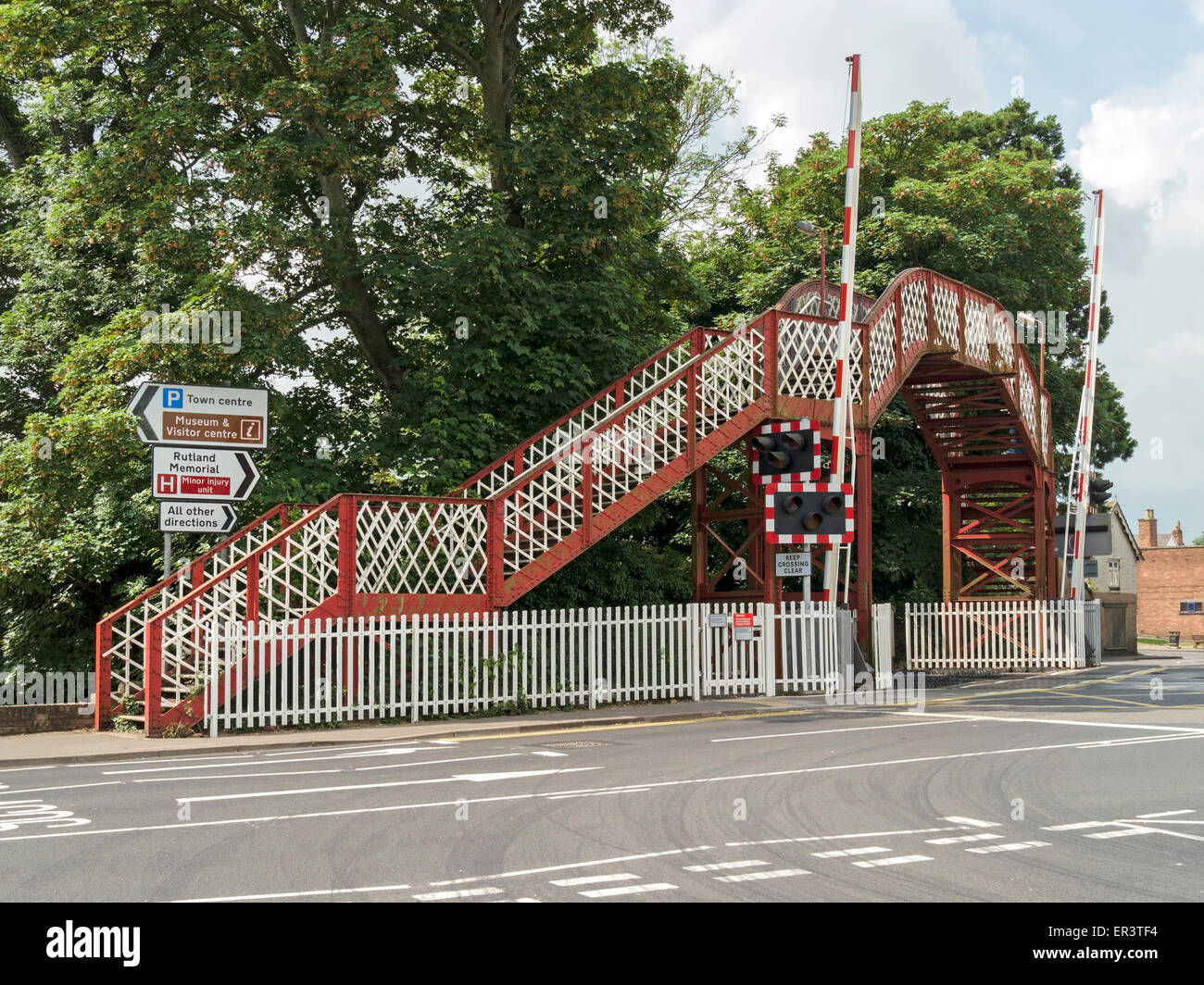 Metal pedestrian footbridge at Oakham railway level crossing, Oakham, Rutland, UK Stock Photo