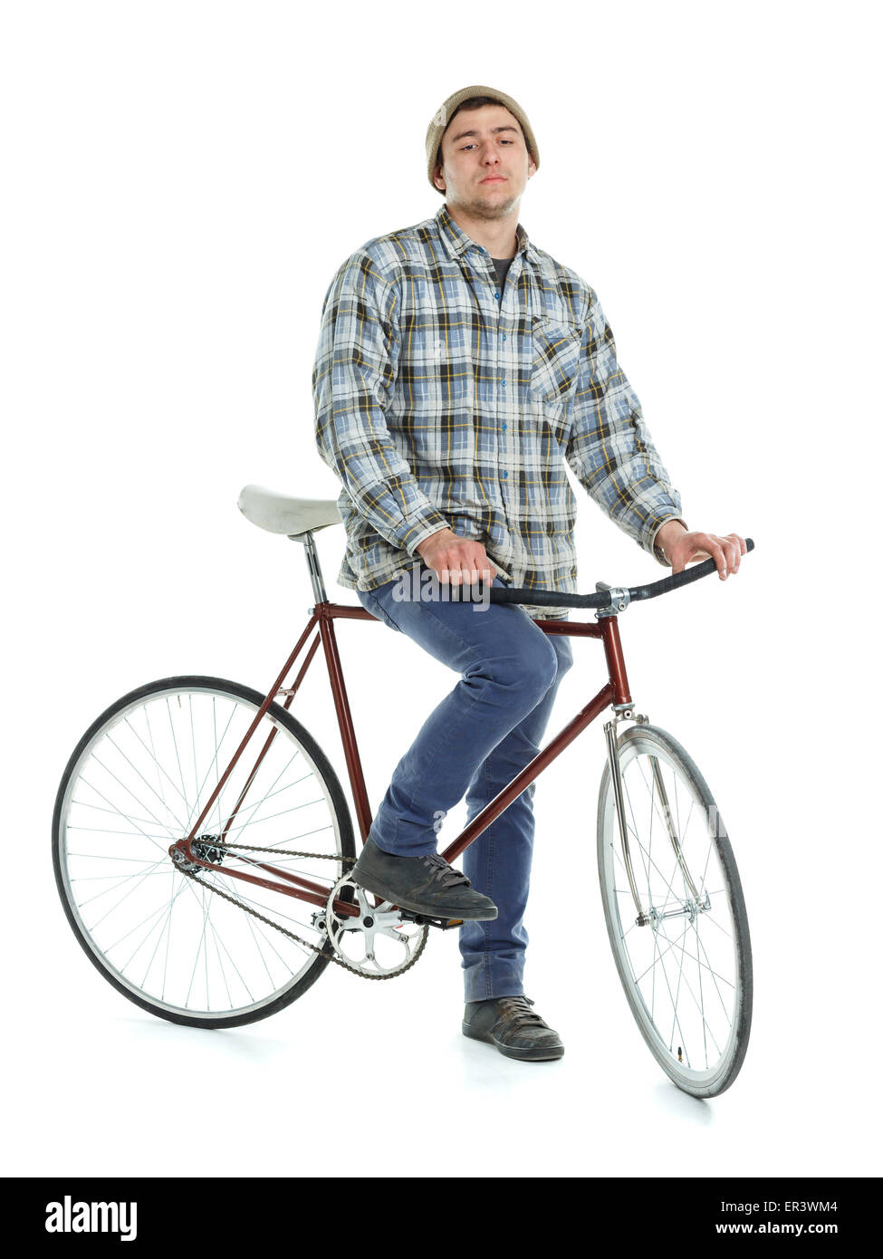 Young man doing tricks on fixed gear bicycle on a white background Stock Photo