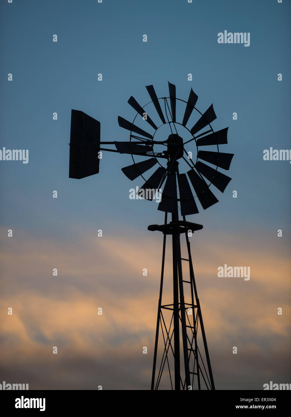 Windmills. Water pump windmill against beautiful sky on Idaho farm. Idaho Stock Photo
