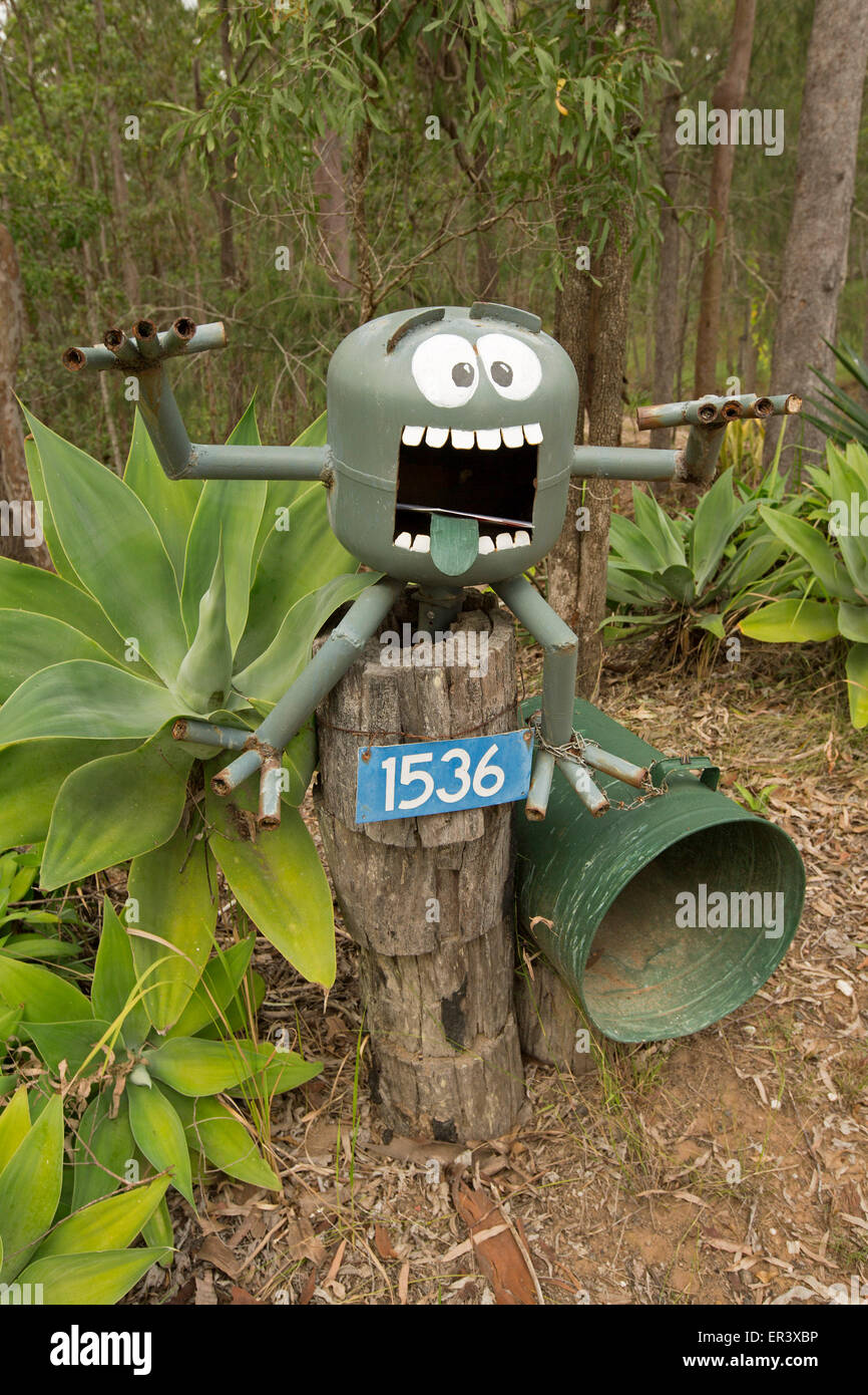 Unique letter / mail box created from gas cylinder in shape of humorous  monster with huge eyes, teeth, legs, arms, gaping mouth Stock Photo - Alamy
