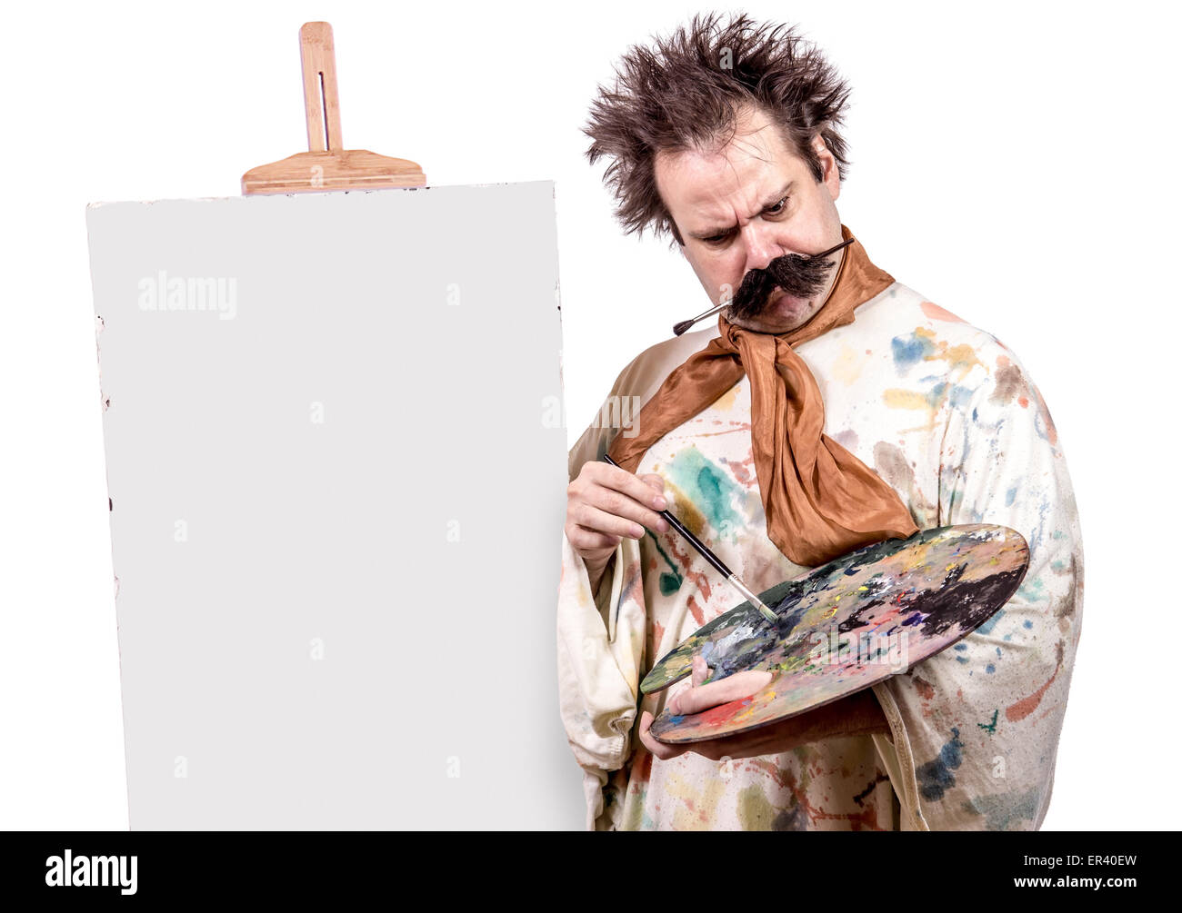 serious painter paints on canvas Stock Photo