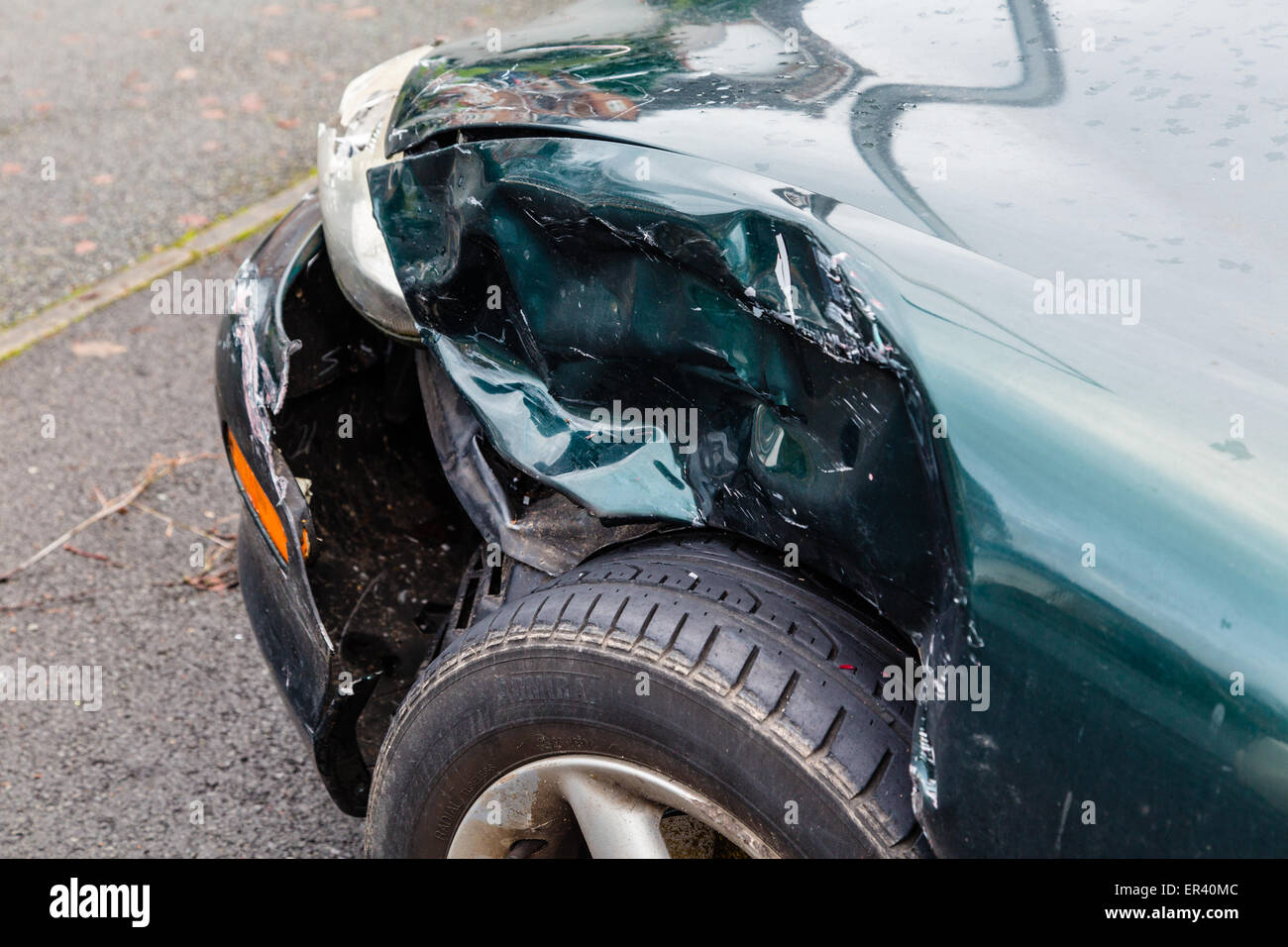 Car with damage to front wing on drive Stock Photo