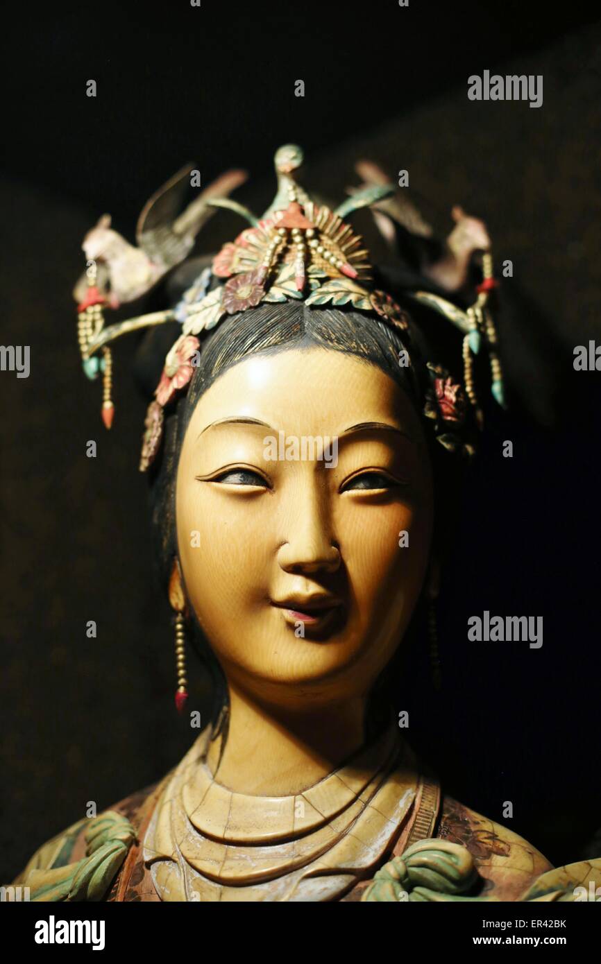 A carved Asian wooden statue of an Asian woman Stock Photo Alamy