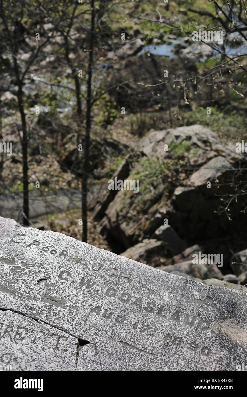 Historic carving of names into leaping rock at Pipestone National