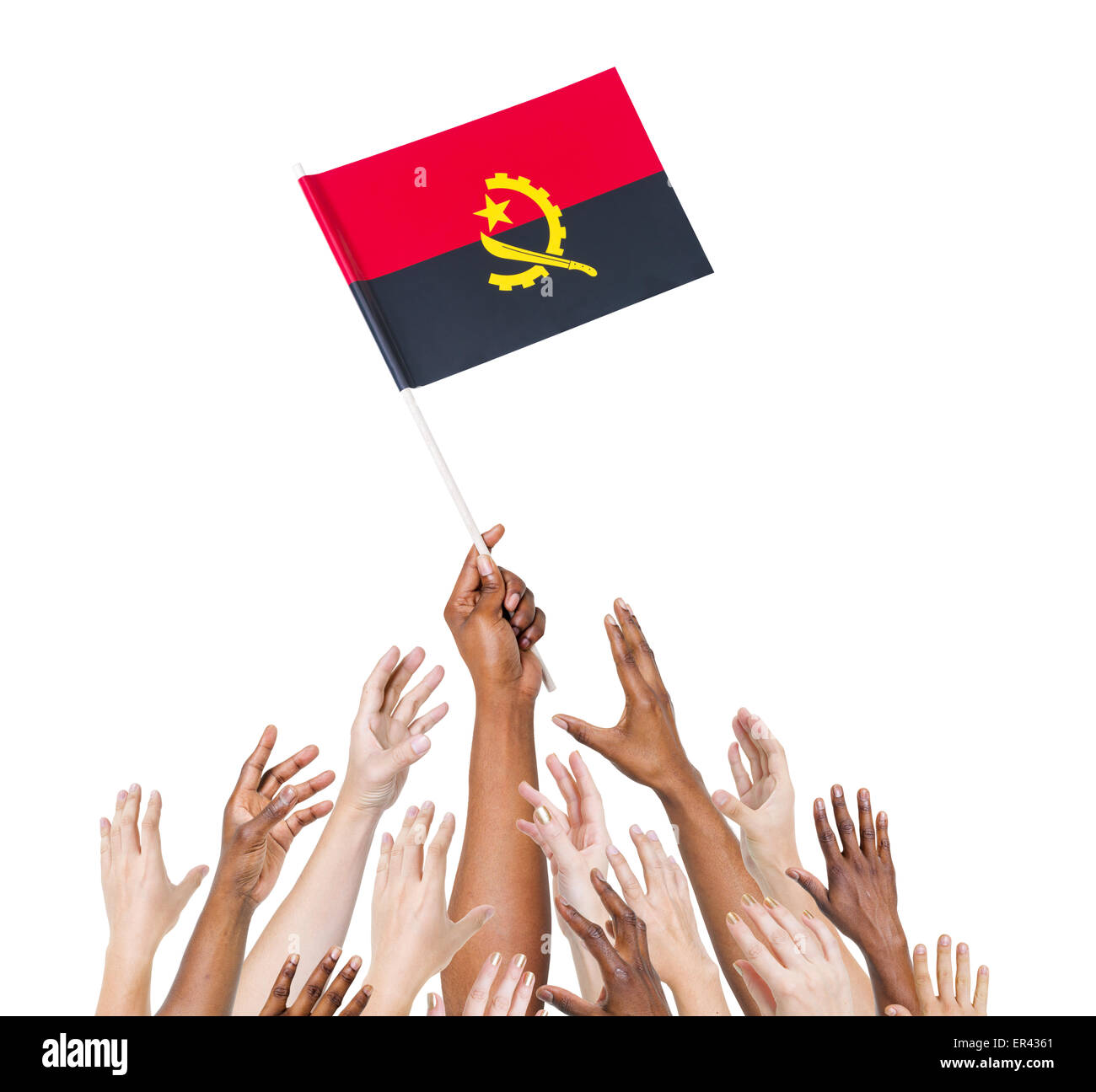 Group of people reaching for and holding the Angolan flag. Stock Photo