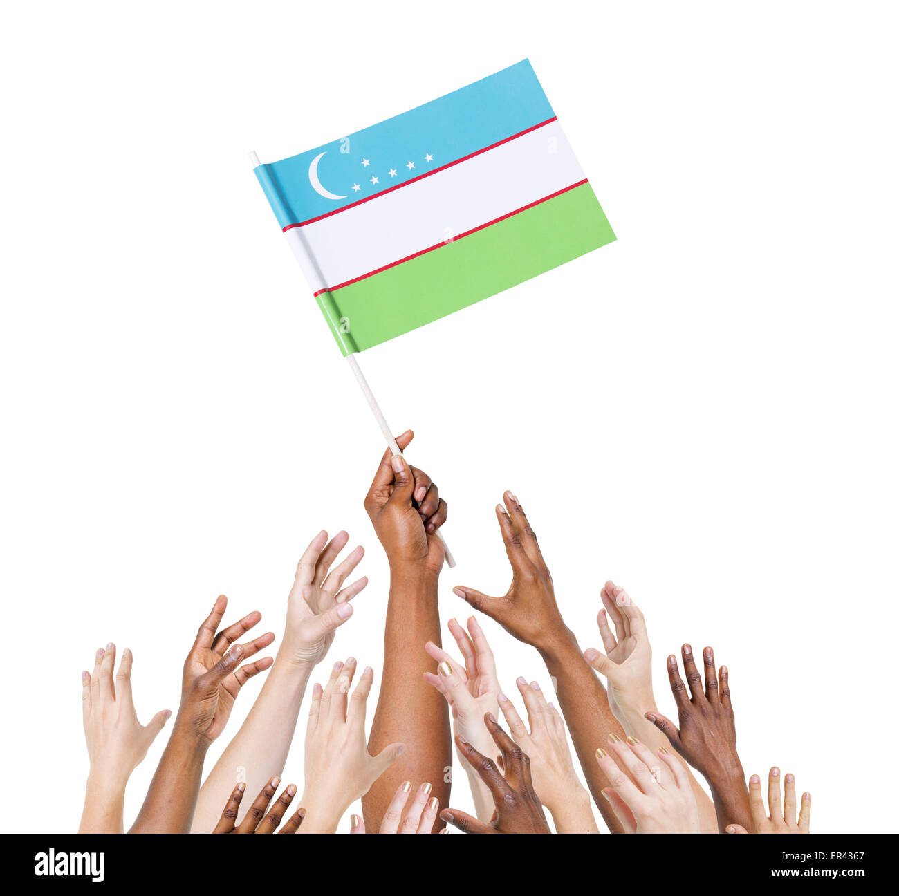 Human hand holding Uzbekistan flag among multi-ethnic group of people's hand Stock Photo