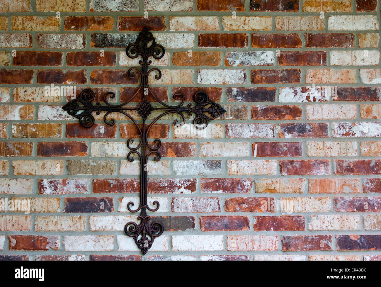 religious cross on brick wall Stock Photo