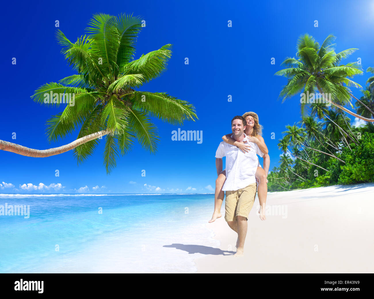 Couple relaxing on the beach Stock Photo - Alamy
