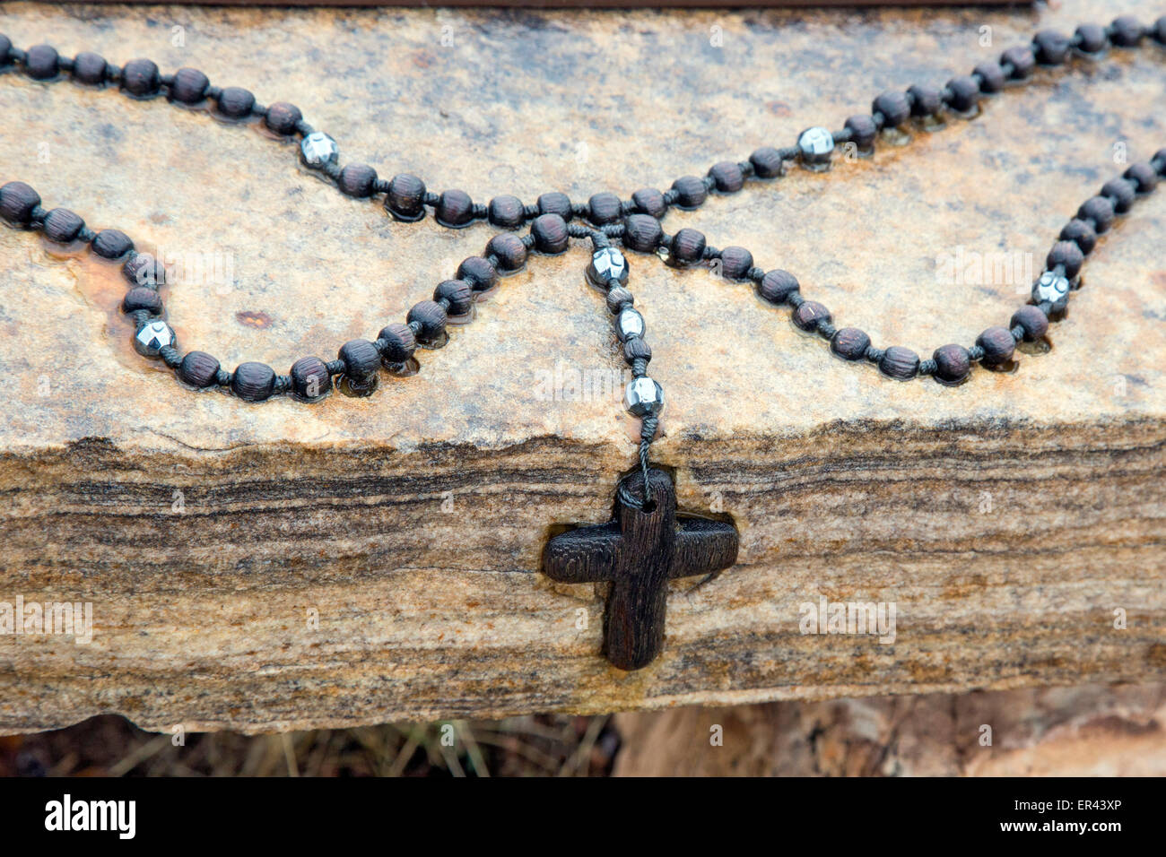 Virginia Dale, Colorado - A rosary on a rock on an outdoor trail at the Abbey of St. Walburga. Stock Photo