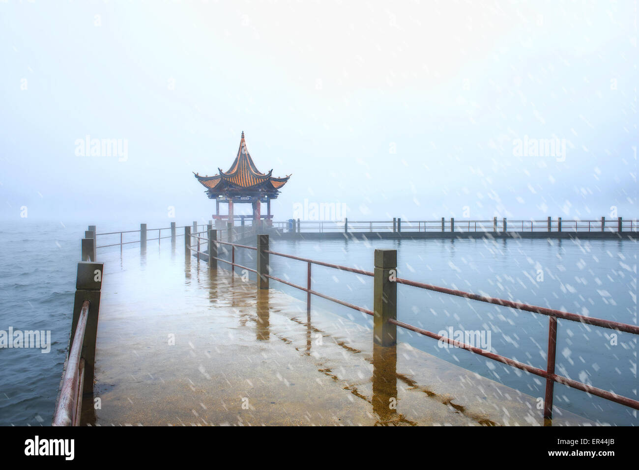 Dali, Yunnan, CHN. 10th Jan, 2015. Dali, CHINA - Jan 09 2015: (EDITORIAL USE ONLY. CHINA OUT) ï¼ˆPhoto has been processedï¼‰Erhai Lake in the rain. Erhai Lake is the largest highland lake next to Dianchi and one of the seven biggest fresh water lakes in China. ''Erhai'' means ''sea shaped like an ear'' in Chinese. Implying that the lake is ear shaped and as large as a sea, it was so named. The lake covers an area of 250 square kilometers and is located about 2 kilometers east of Dali. It is like a crescent lying between Cangshan and Dali city as seen from Cangshan Mount. In a sunny day, the c Stock Photo