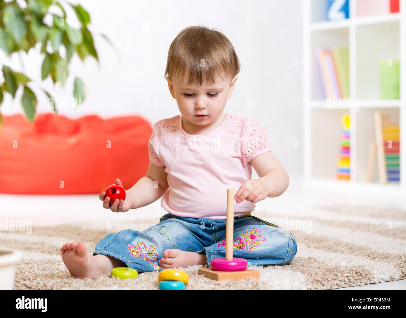 Child girl playing with toy indoors at home Stock Photo - Alamy