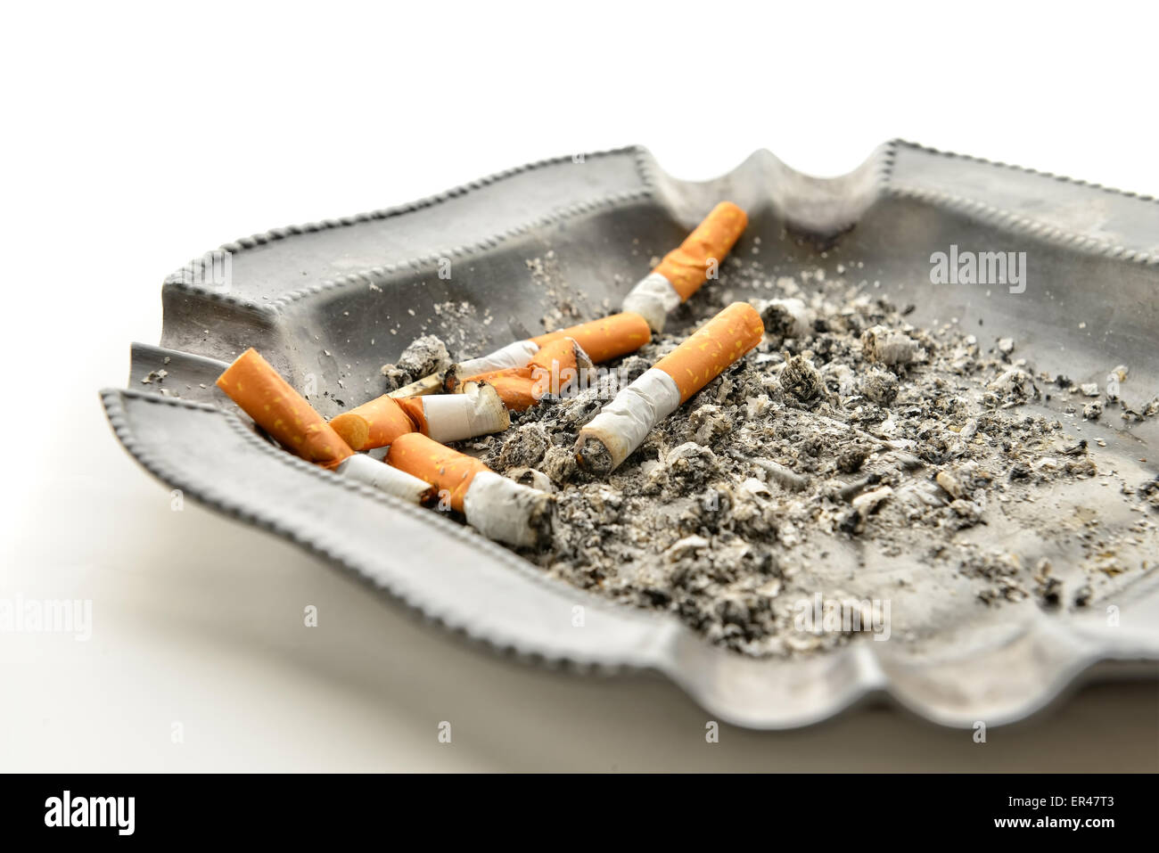 Cigarettes and ashtray on white table closeup Stock Photo