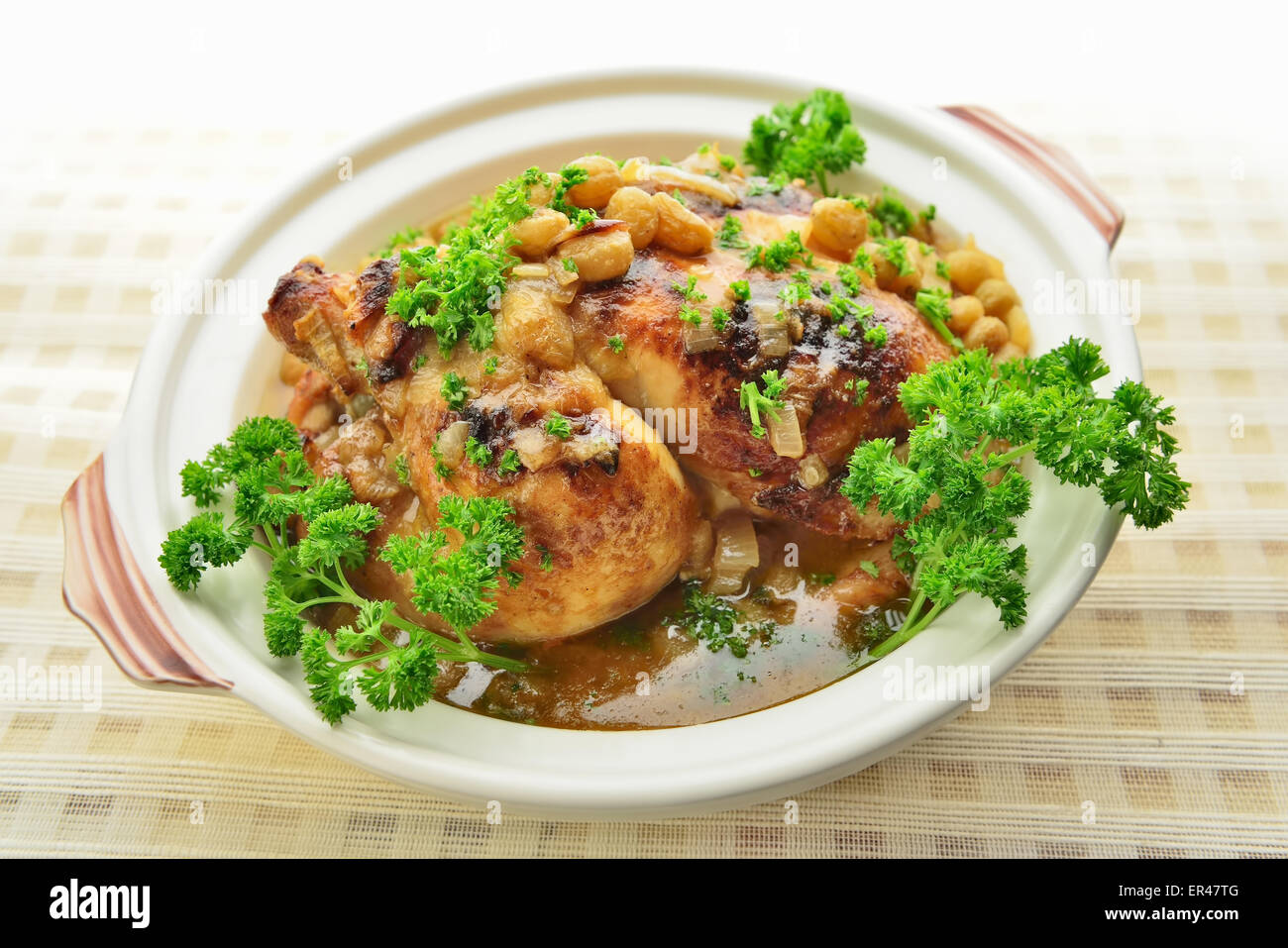 Baked chicken with grapes, white wine, onion, garlic, butter, mustard and parsley Stock Photo