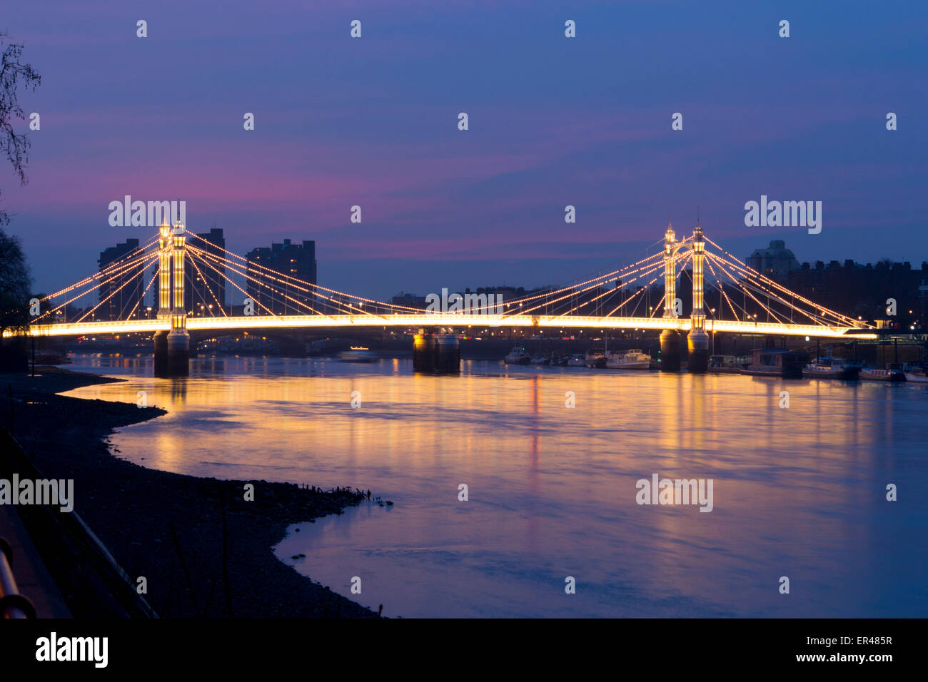 Albert Bridge at night and River Thames Chelsea London England UK Stock Photo