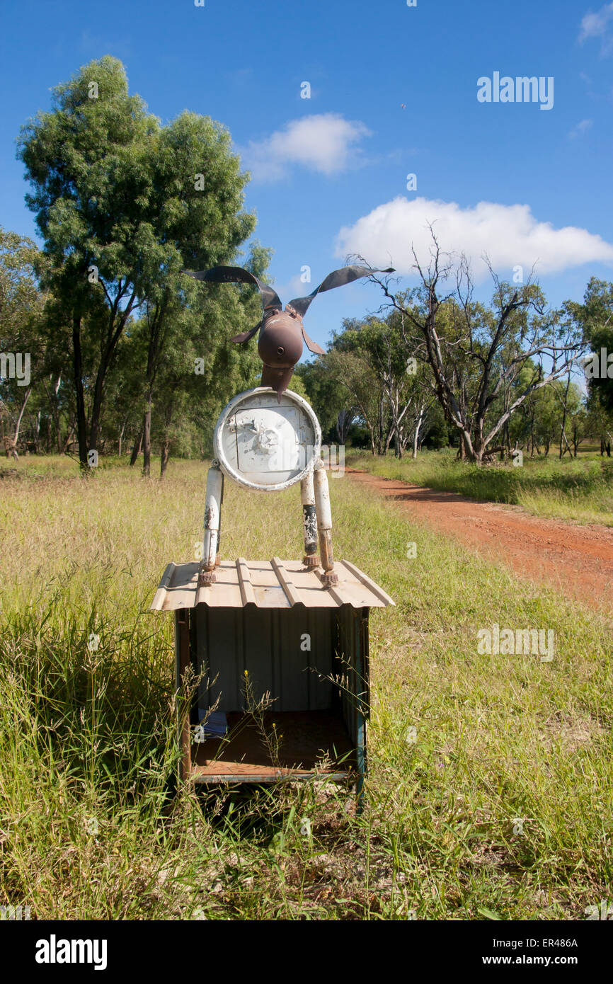 Metal cow mailbox Brigadoon with red dirt track leading to property Near Mitchell Queensland Australia Stock Photo
