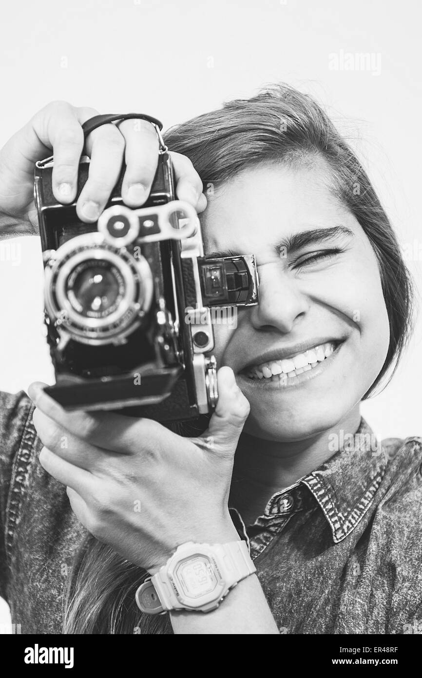 Teenager girl with an old folding camera portrait. Stock Photo