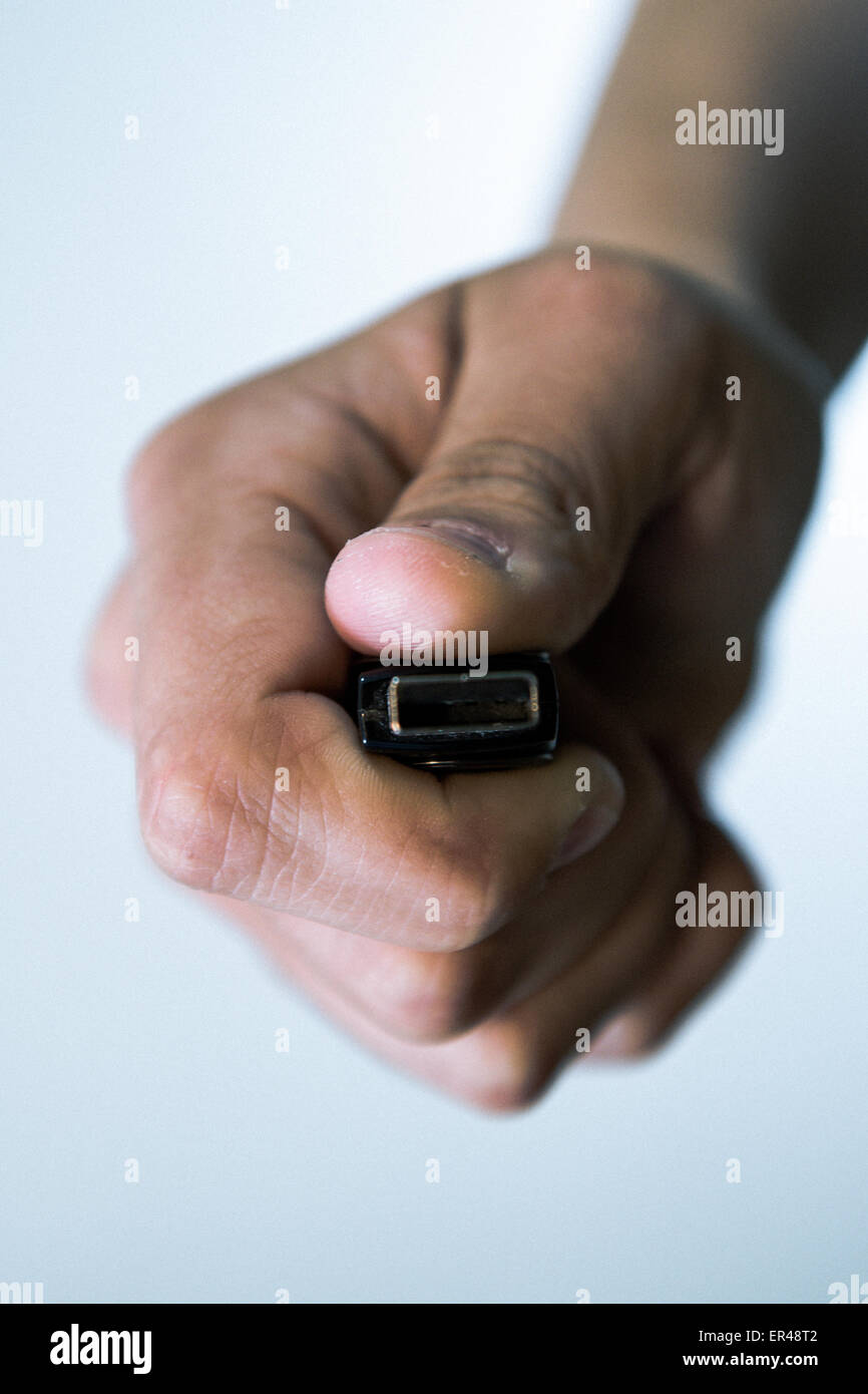 Girl is holding USB memory stick in her left hand. Futuristic lights in the foreground are visible. Stock Photo