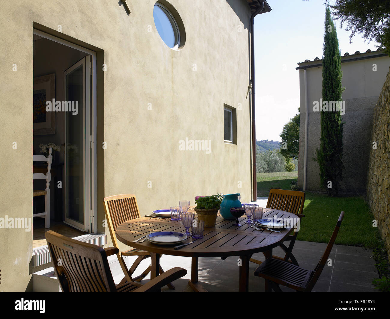 patio with table set up for lunch in a country house in Tuscany Stock