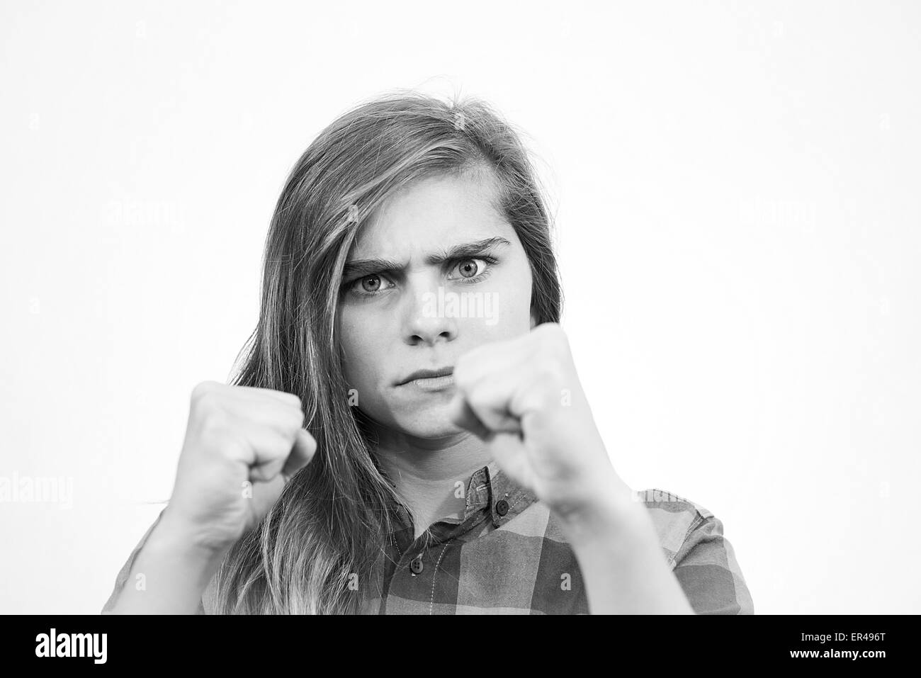 Teenage girl is ready to fight with the world. White background. Stock Photo
