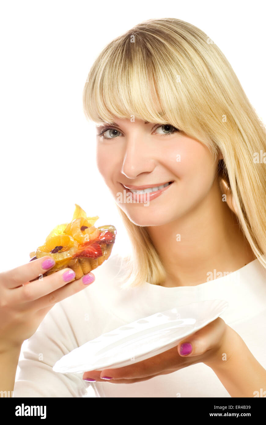 Beautiful young woman with fruit cake isolated on white background