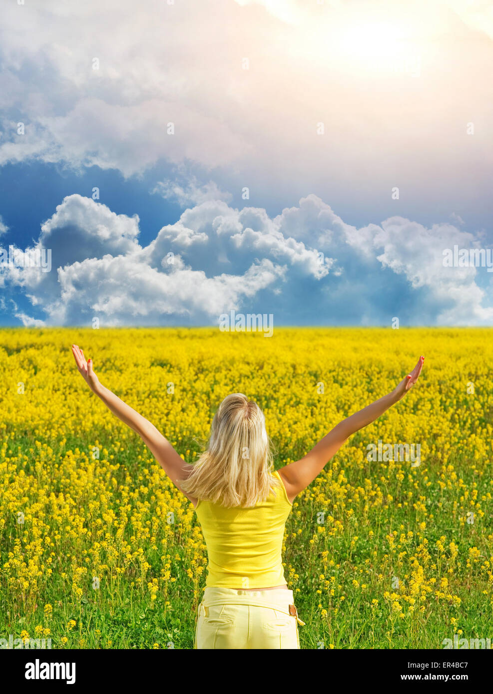 Beautiful young woman in a flower field Stock Photo - Alamy