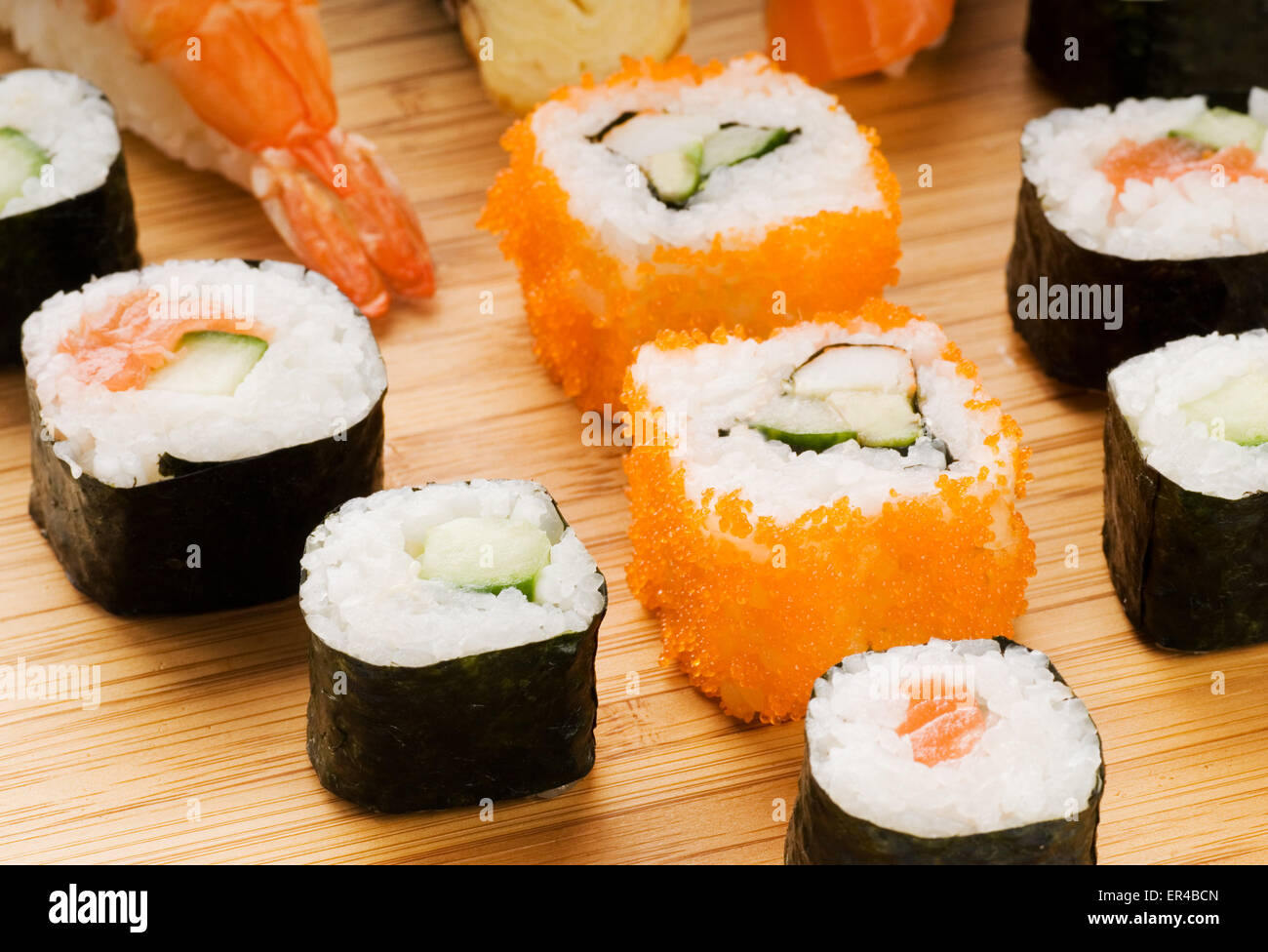 Different types of sushi on a bamboo plate Stock Photo