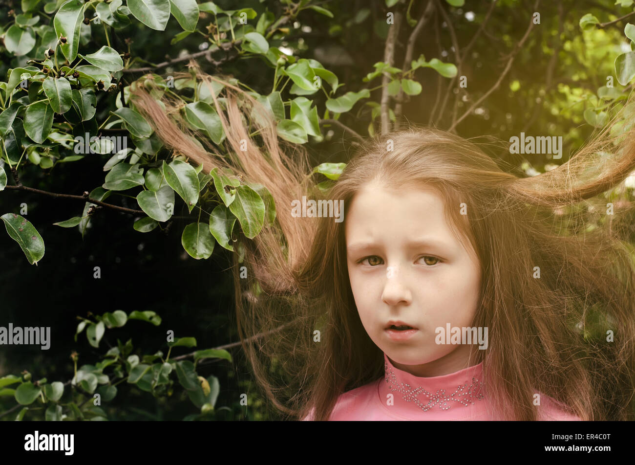 portrait of the nice little girl near a tree in the summer Stock Photo ...
