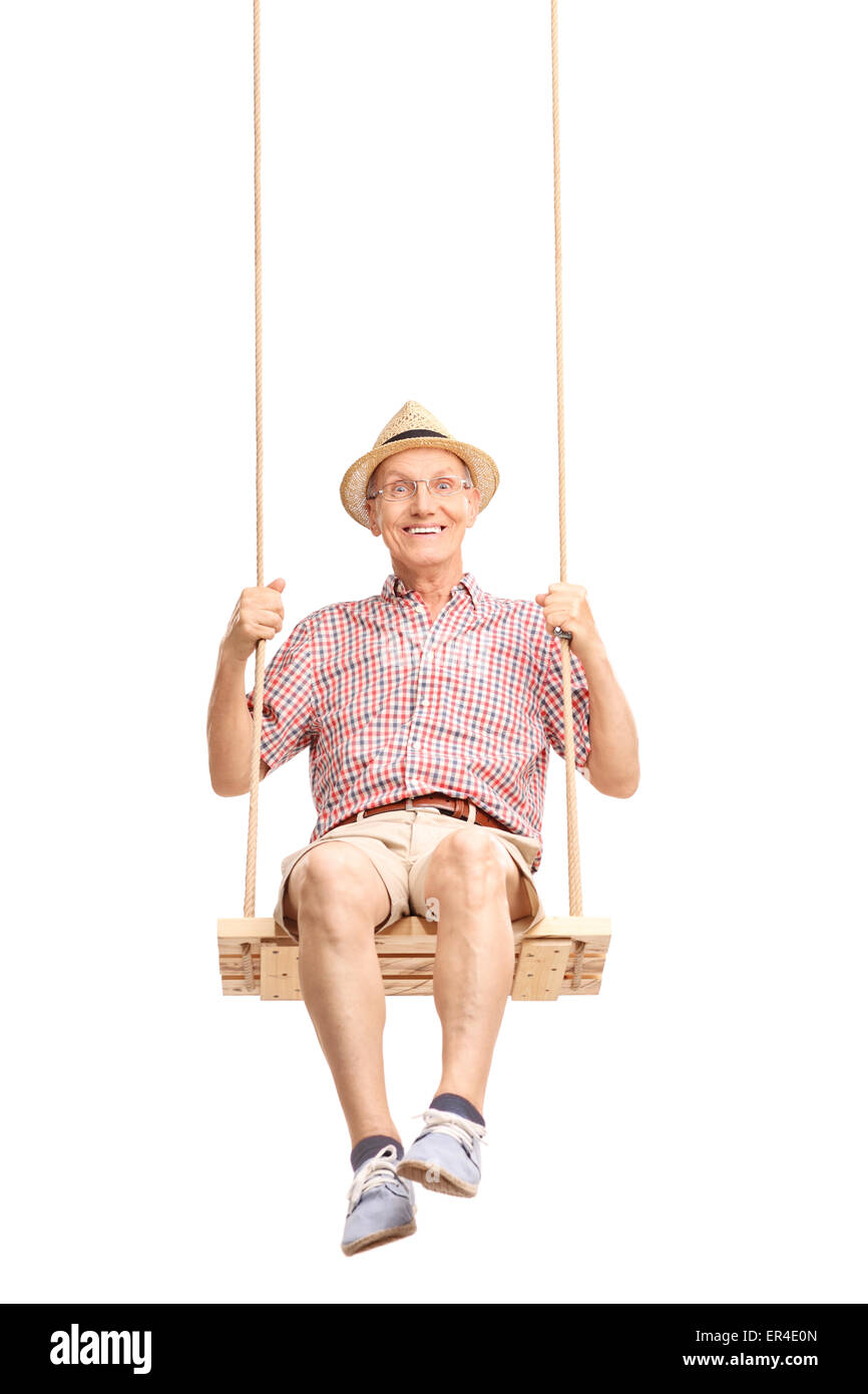 Vertical shot of a playful senior swinging on a swing and looking at the camera isolated on white background Stock Photo