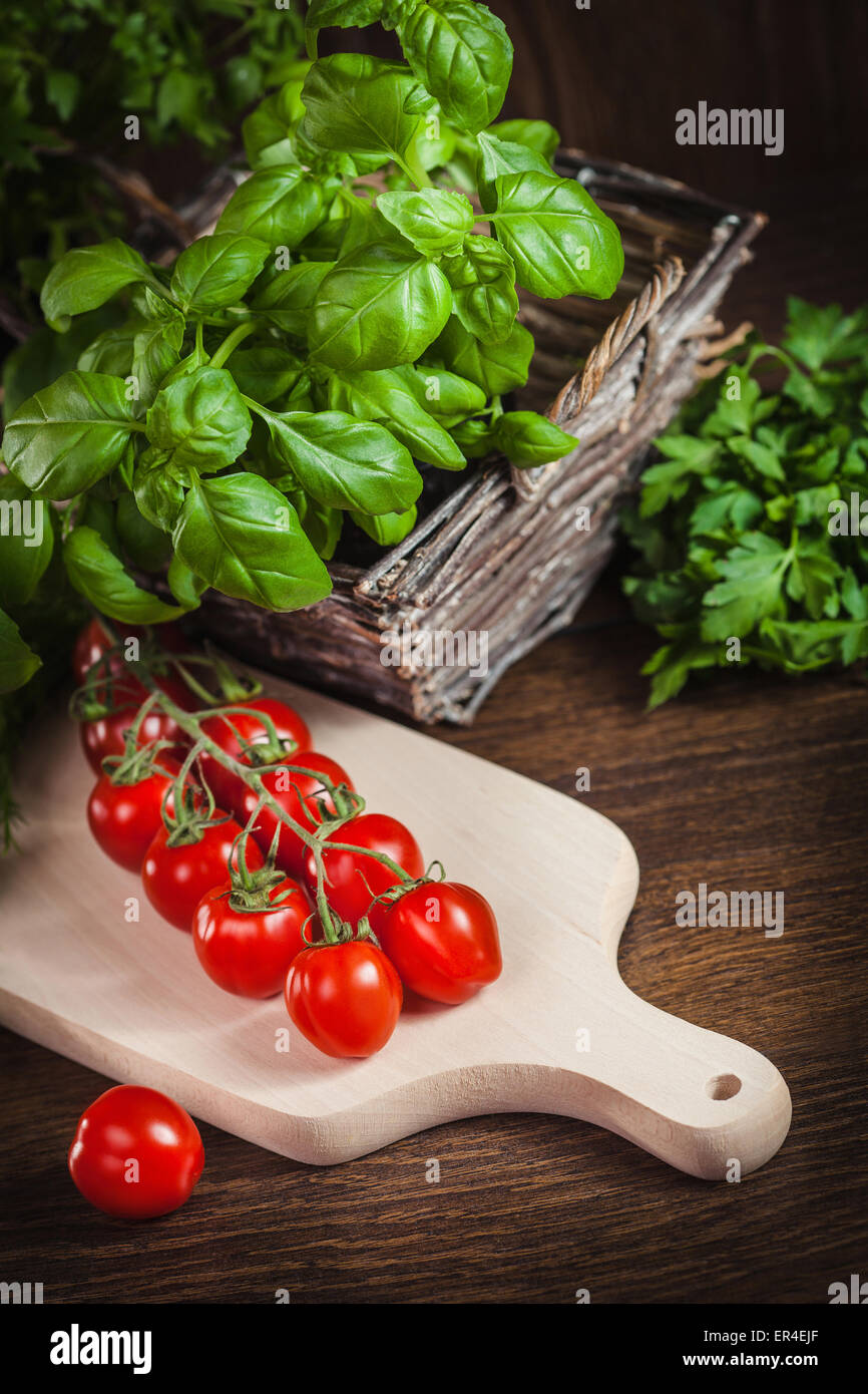 Tomatoes and vegetables in a basket Stock Photo - Alamy