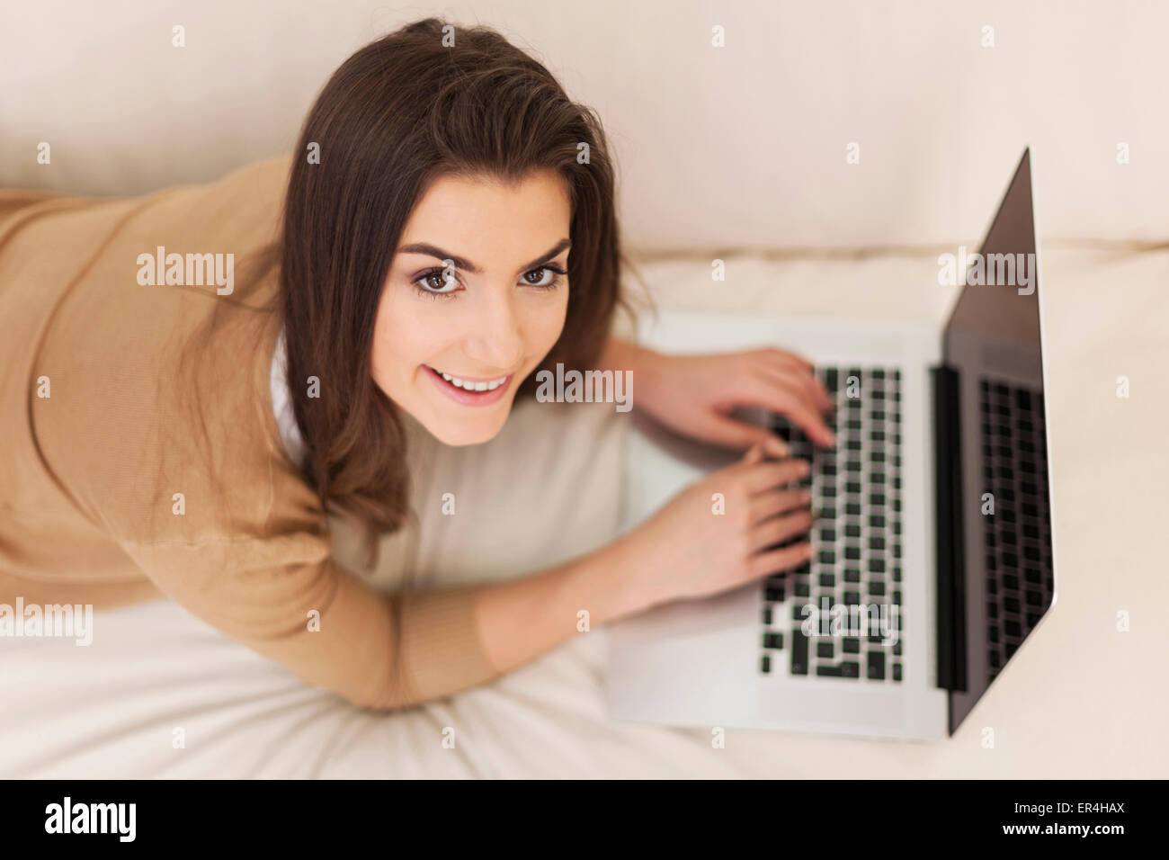 Beautiful woman relaxing with her laptop Stock Photo - Alamy