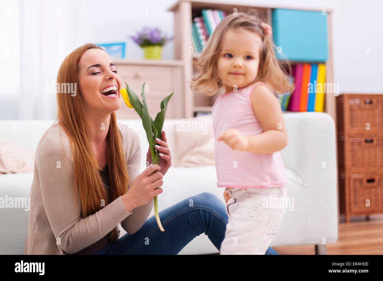 Beautiful mother enjoying the flower which she received from daughter. Debica, Poland Stock Photo