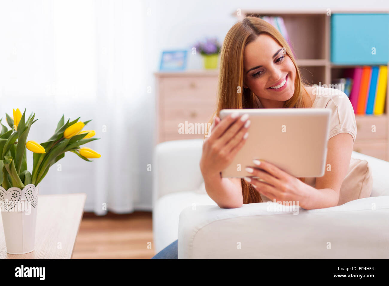 Happy woman with digital tablet at home. Debica, Poland Stock Photo