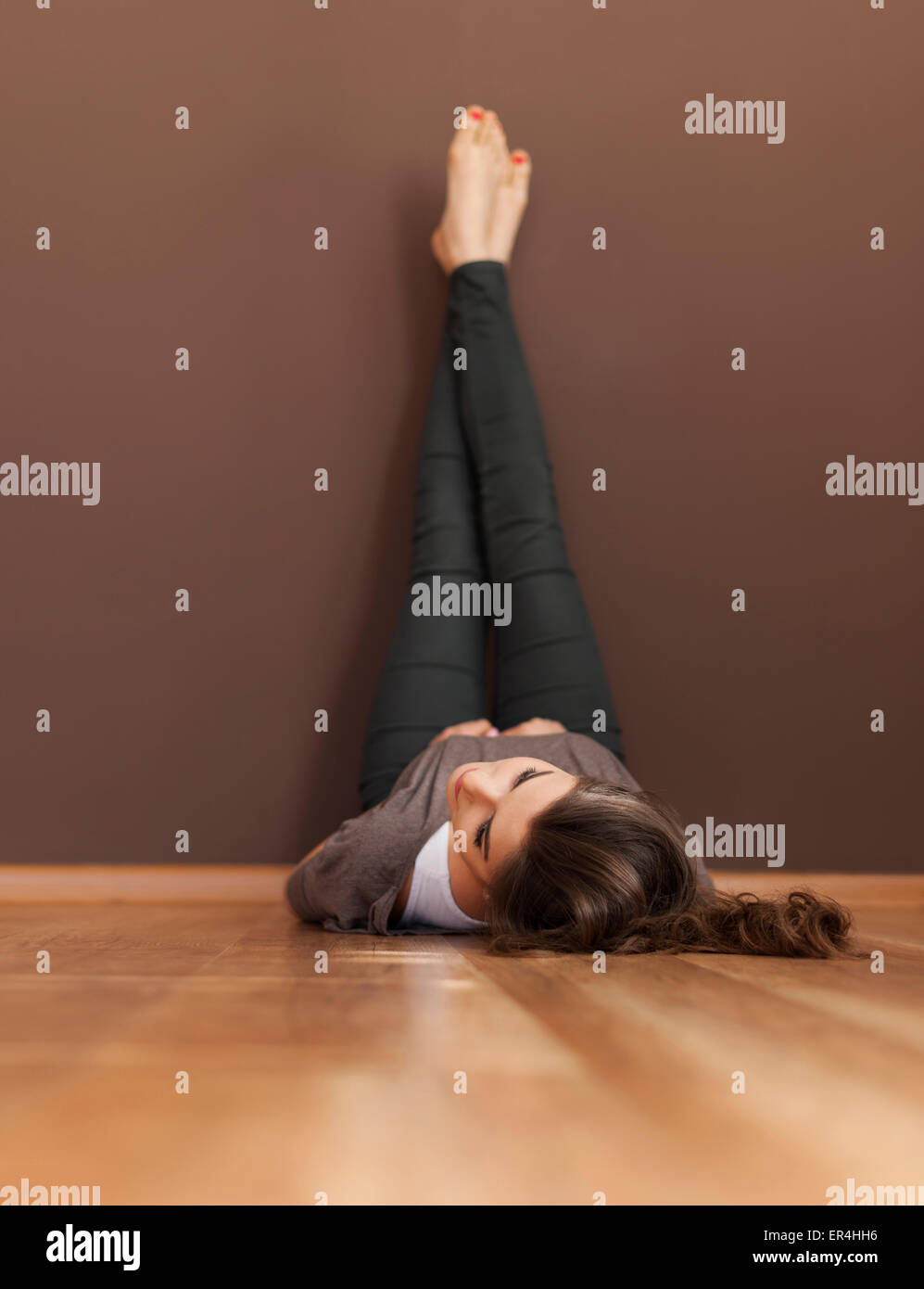 Beautiful woman lying on a wooden floor Stock Photo