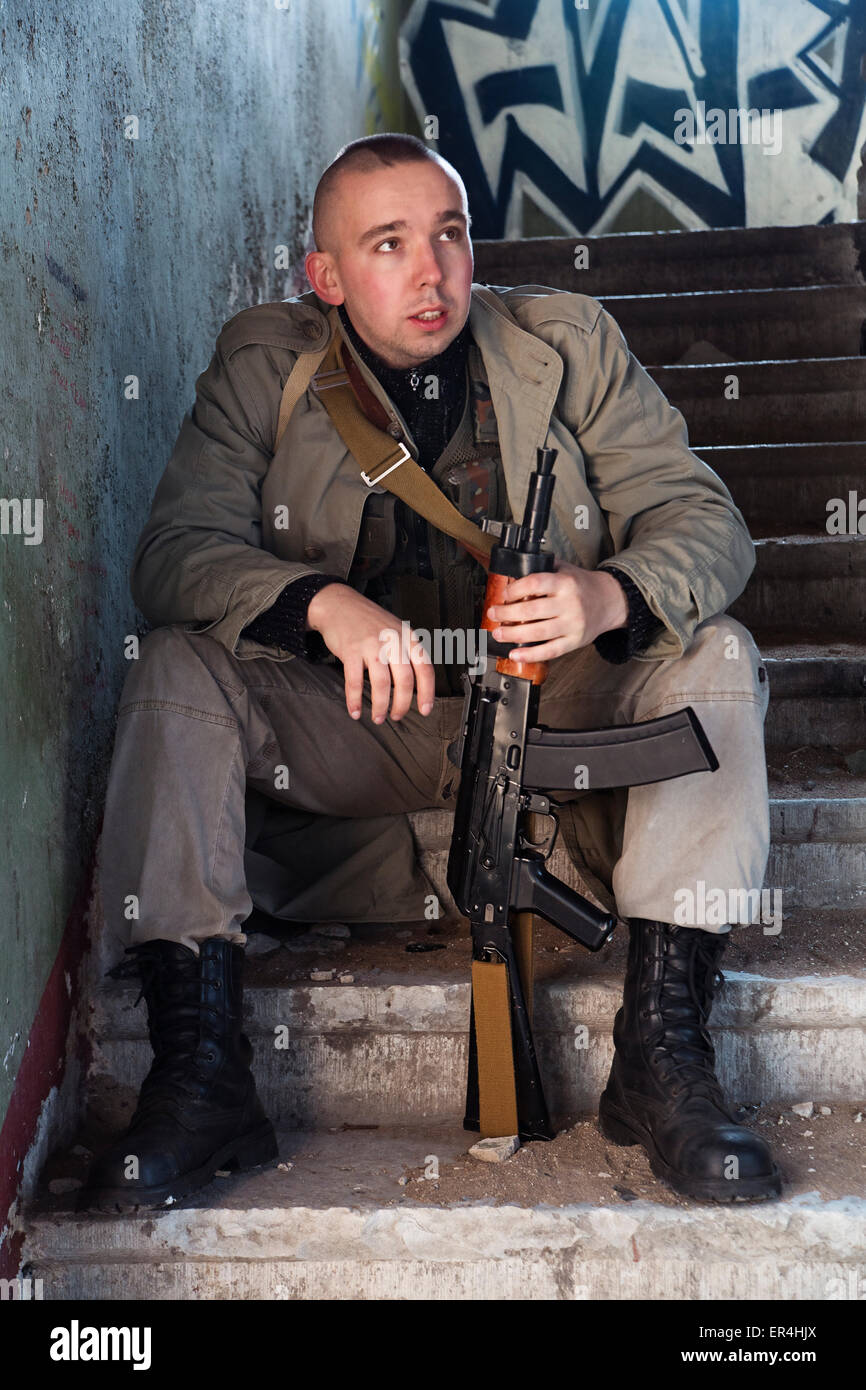 The skinhead hitman sitting on the stairs Stock Photo