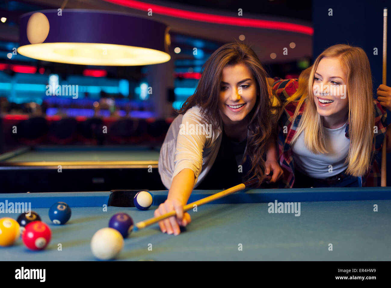 Billiards game. young friends playing pool together Stock Photo - Alamy