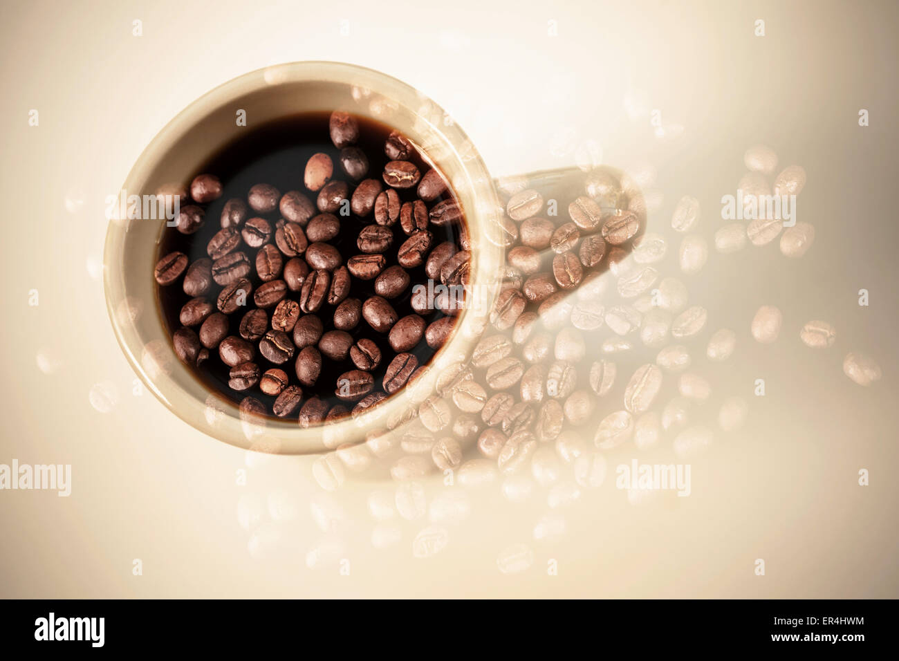White coffee cup stand on a table over dark rusted coffee beans texture. Double exposure photo with vintage style photo filter e Stock Photo