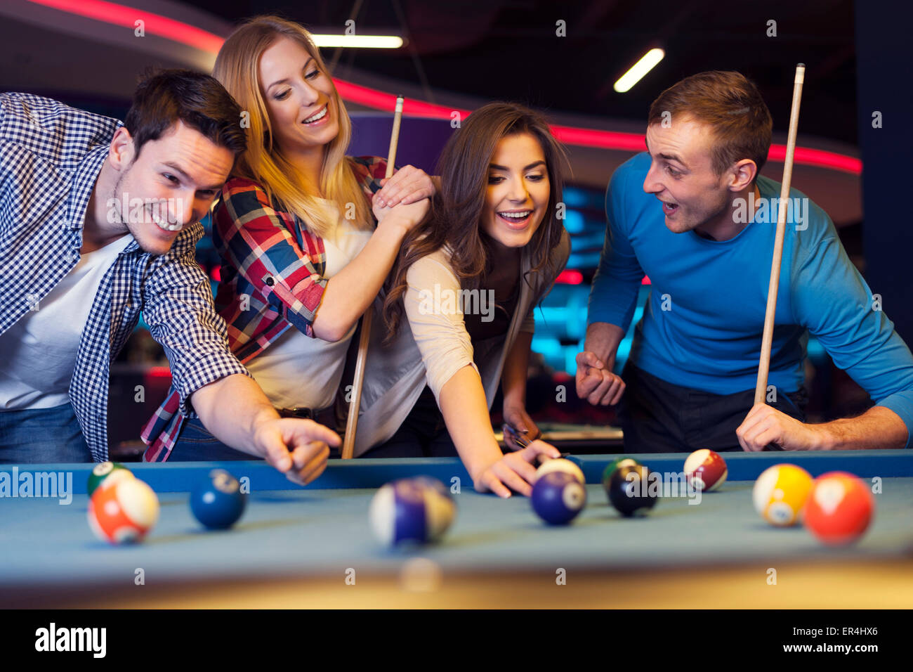 Billiards game. young friends playing pool together Stock Photo - Alamy