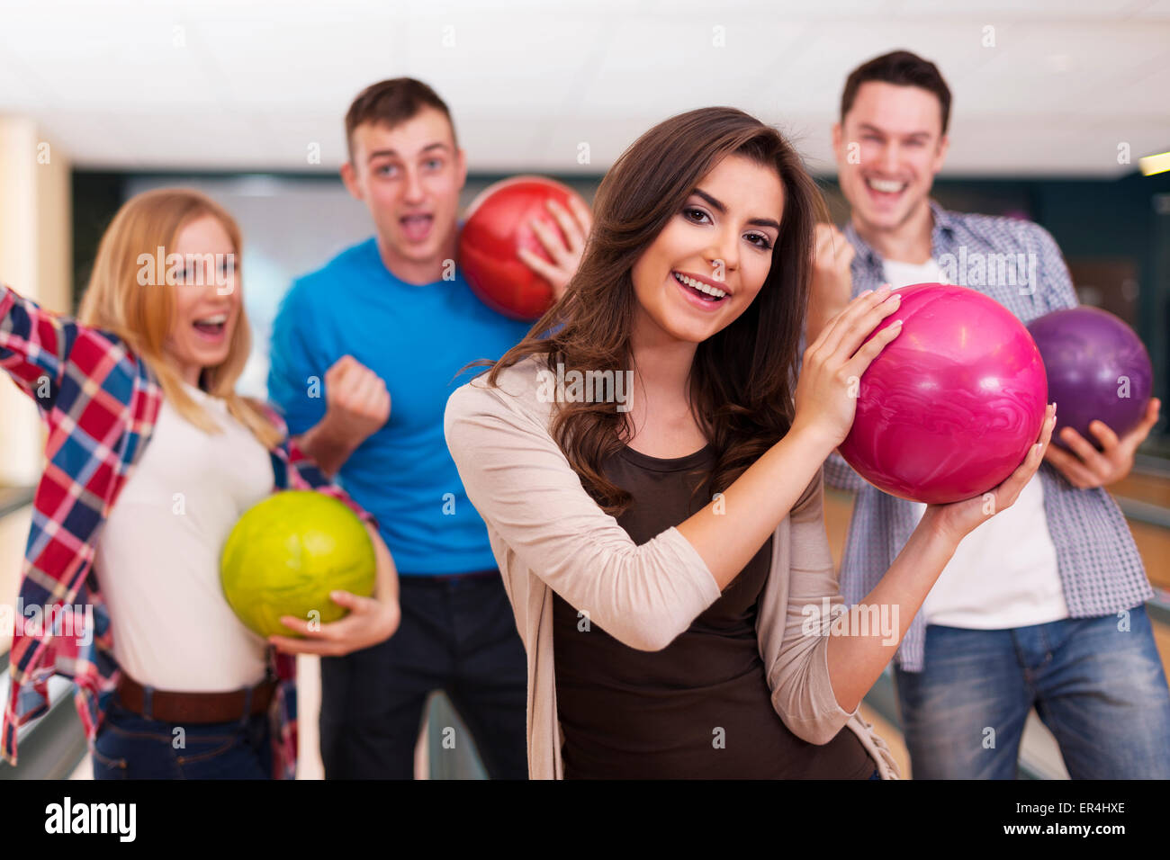 Friends bowling together Stock Photo